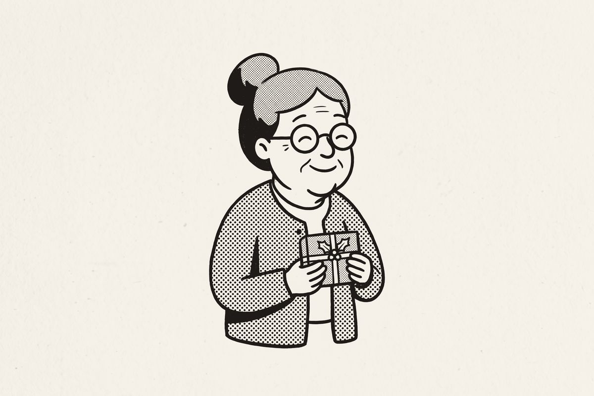 A grandmother holding a small wrapped Christmas gift to her chest, eyes closed, smiling.