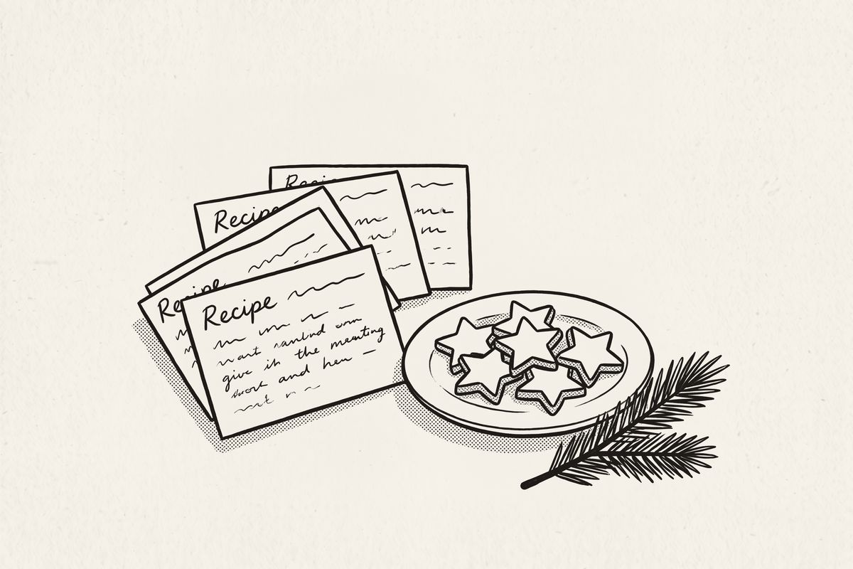 Four recipe cards fanned out beside a plate of star-shaped Christmas cookies.