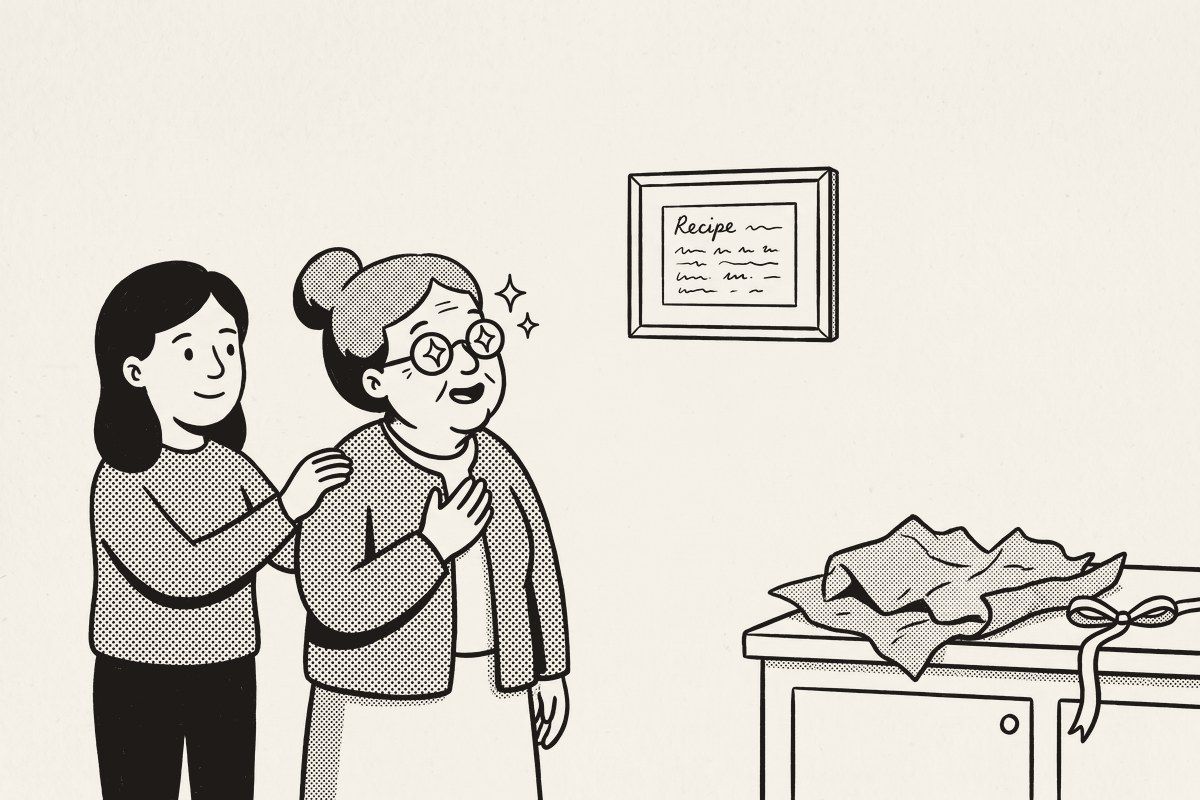 An older woman, hand on her heart, looking at her framed recipe card on the kitchen wall, her daughter-in-law beside her.