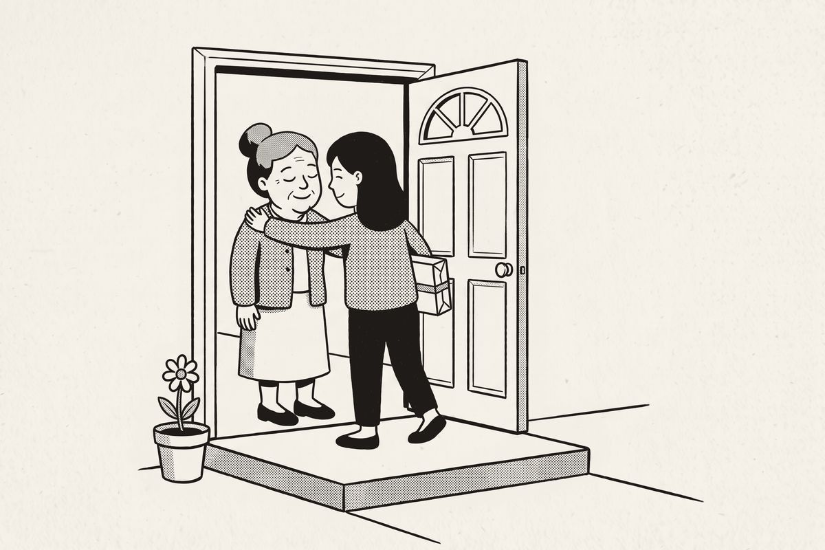 A friend holding a wrapped parcel hugs a woman at her front door.