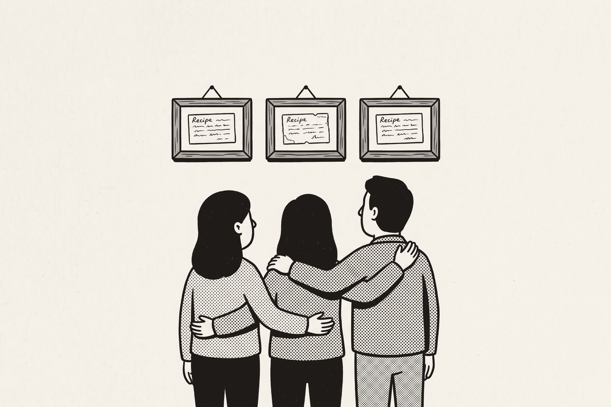 Three siblings, arms around each other, looking up at three matching framed recipe cards.