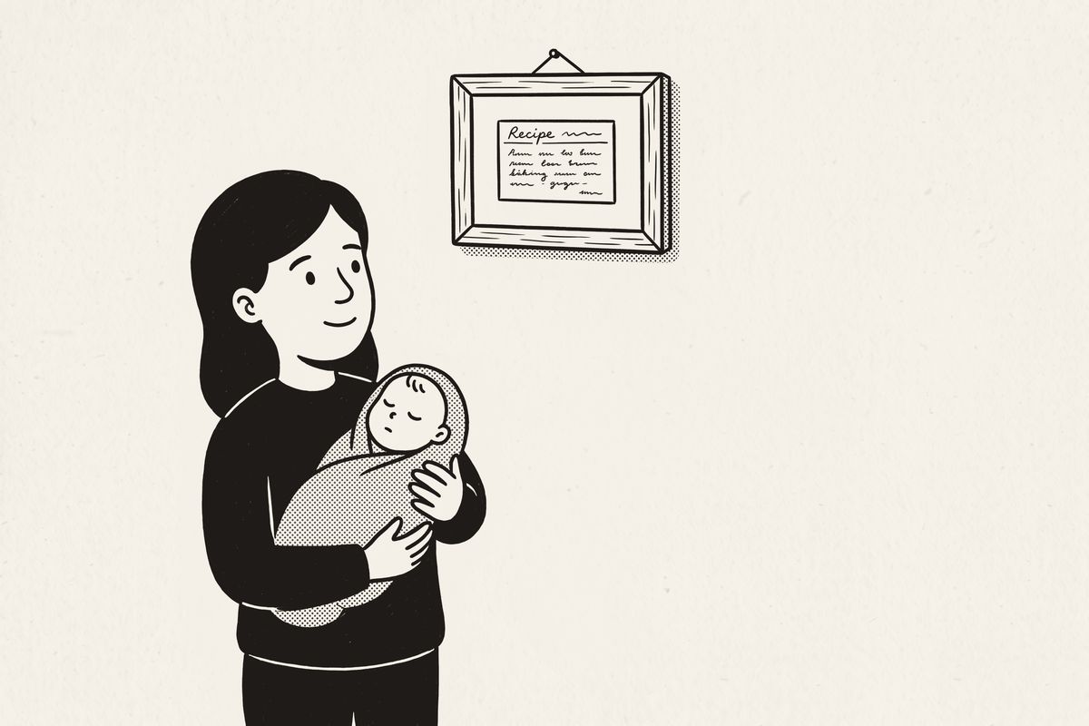 A young mother holding her sleeping baby, looking up at a framed family recipe card.