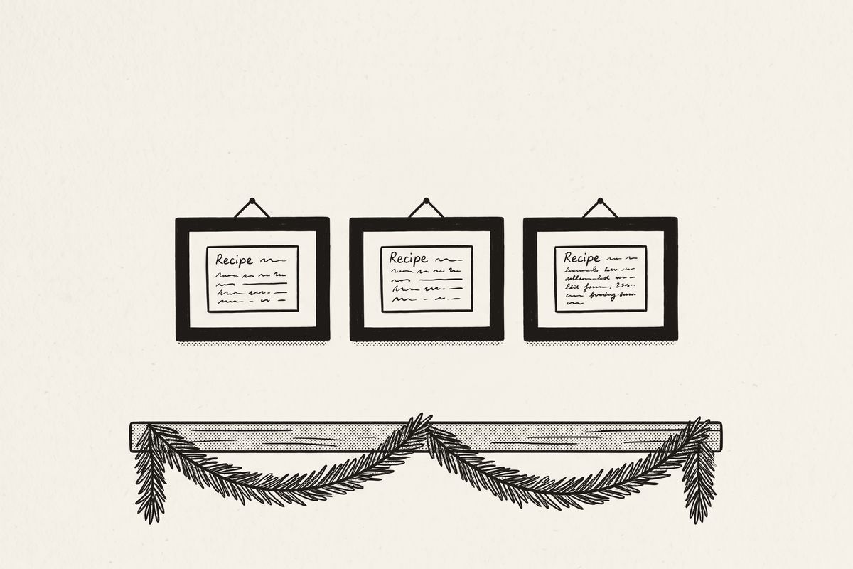 Three framed recipe cards in different handwriting in a row on a kitchen wall, a pine garland below.