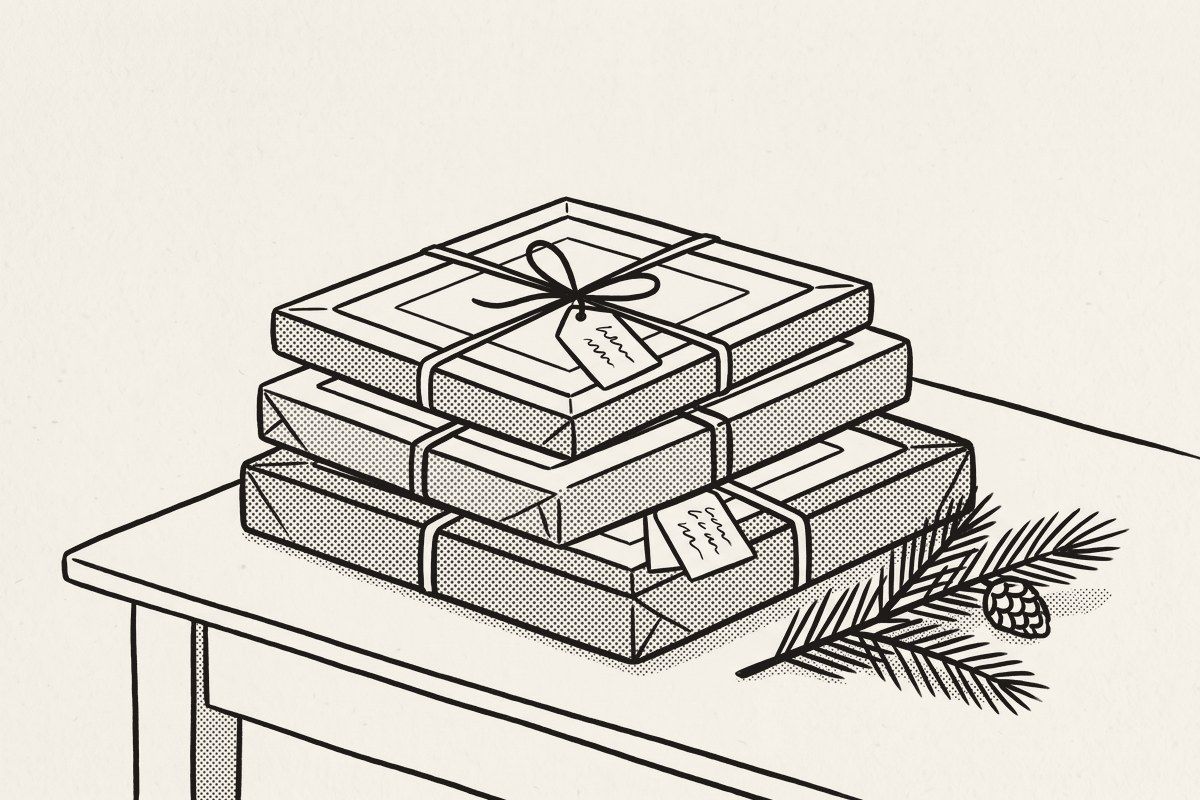 Three identical wrapped gifts with blank tags, beside a sprig of pine.