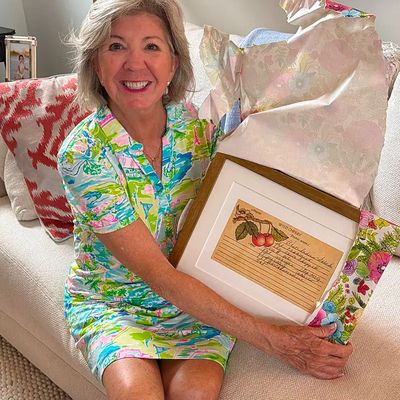 Mary unwraps her mother's framed West Indies Salad recipe.